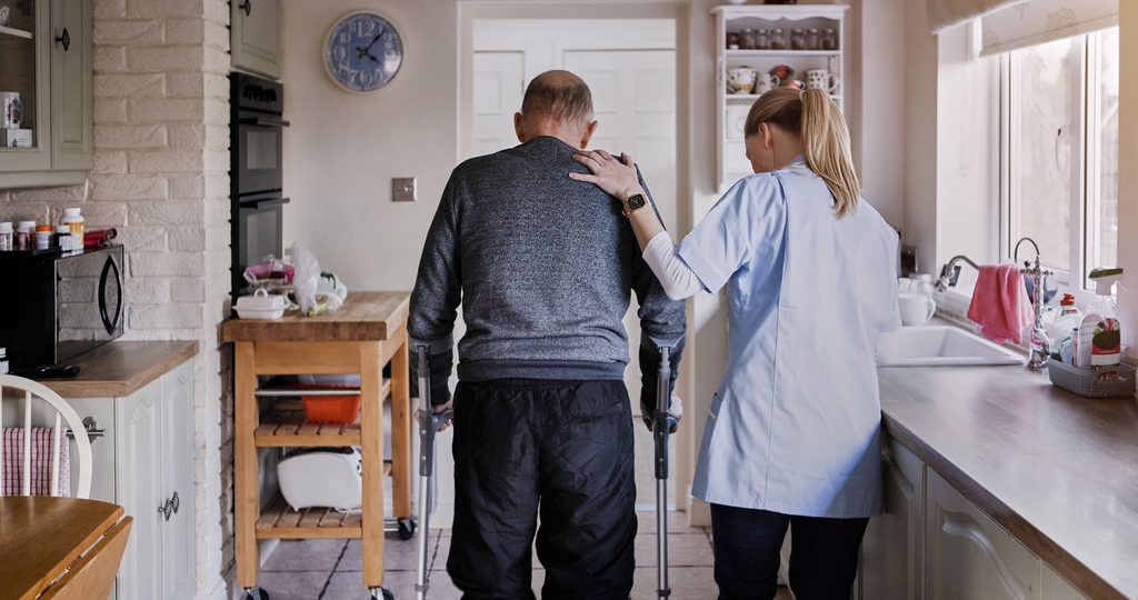 Daily routine care caregiver helping a client at home